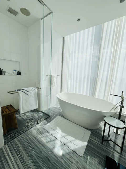 Luxury bathroom with natural marble vanity and stone tile floor cleaned to showroom standards by ELcleaning in NYC