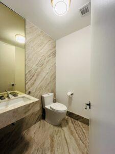 Luxury bathroom with natural marble vanity and stone tile floor cleaned to showroom standards by ELcleaning in NYC