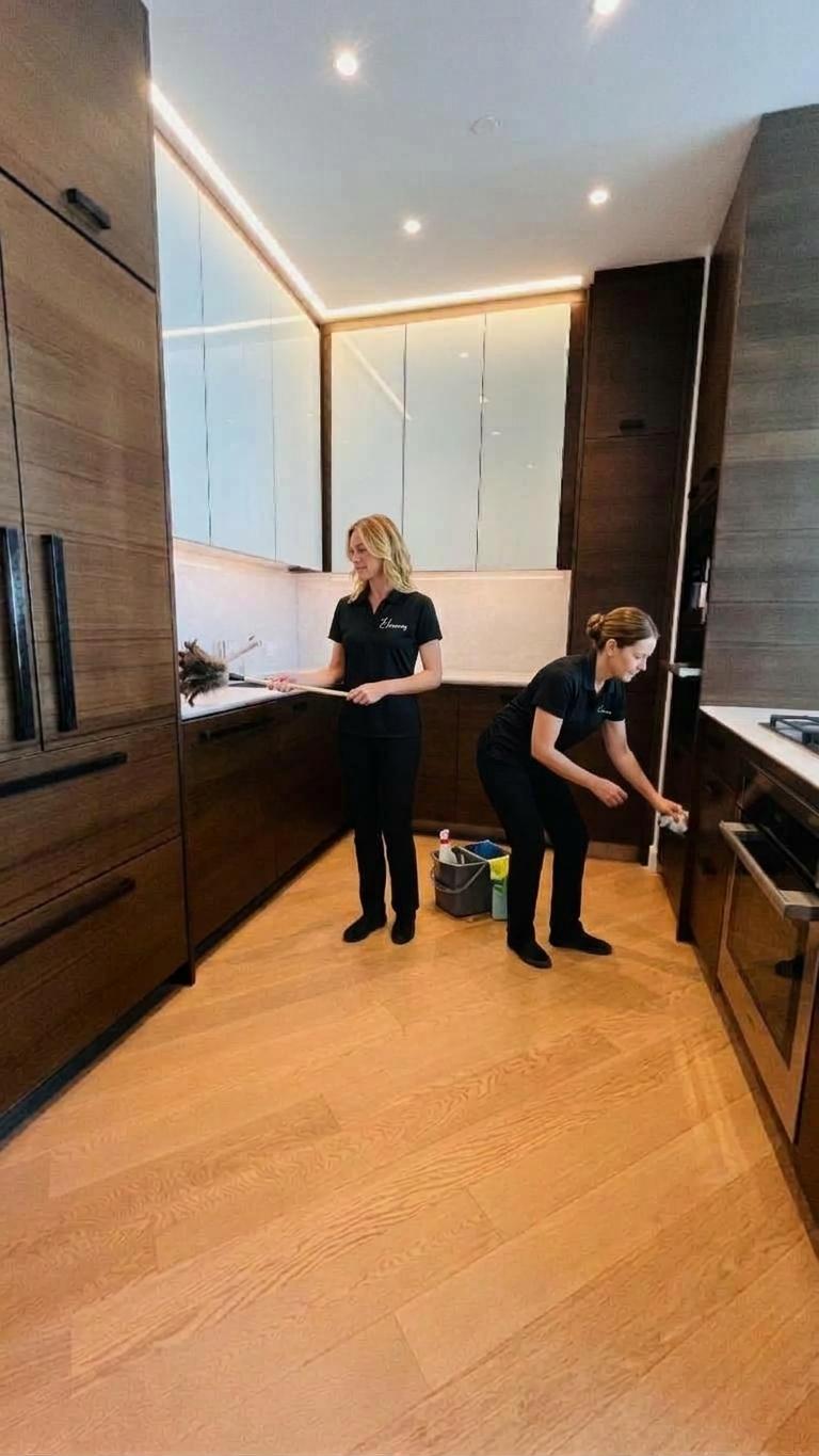 Elcleaning two team members are deep cleaning kitchen at Hudson Yards Luxury apartment 10001